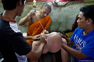 Monk doing a Sak Yant using a Khem Sak (metal spike)
