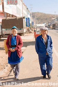 elderly chinese man and woman smiling walking down the street, china, shuanglang, erhai lake, near dali, yunnan province